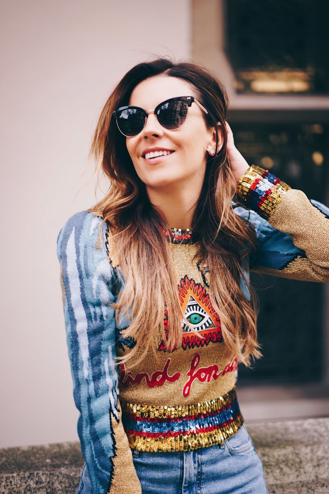 blogger juliet angus wearing gucci evil eye sweater with mih jeans and anita flavina boots